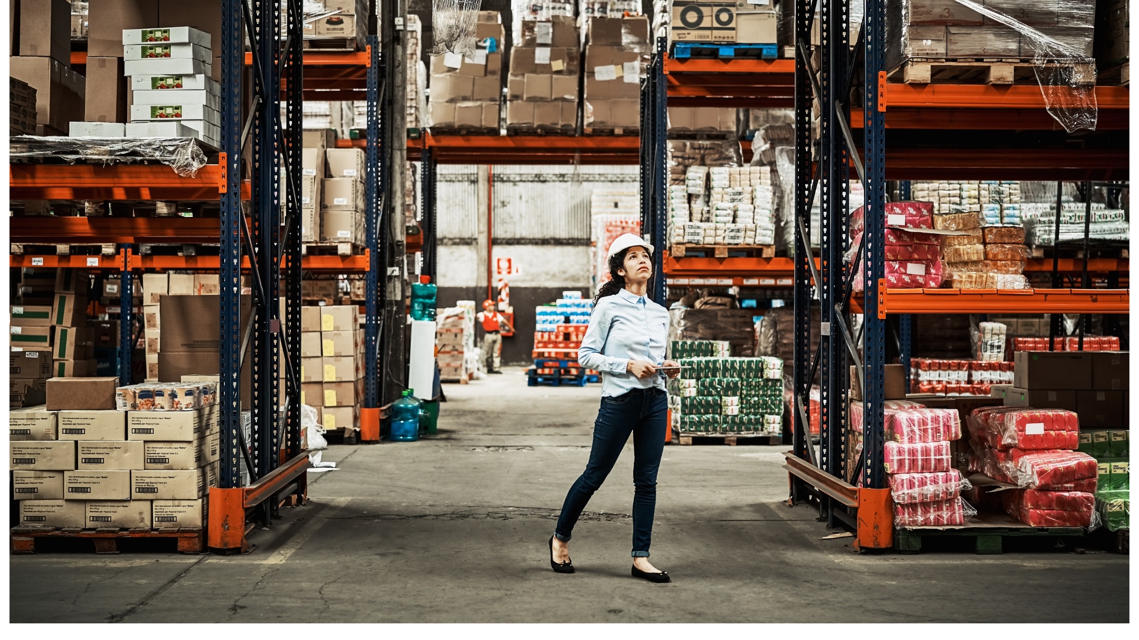 Person in warehouse with tablet to count inventory